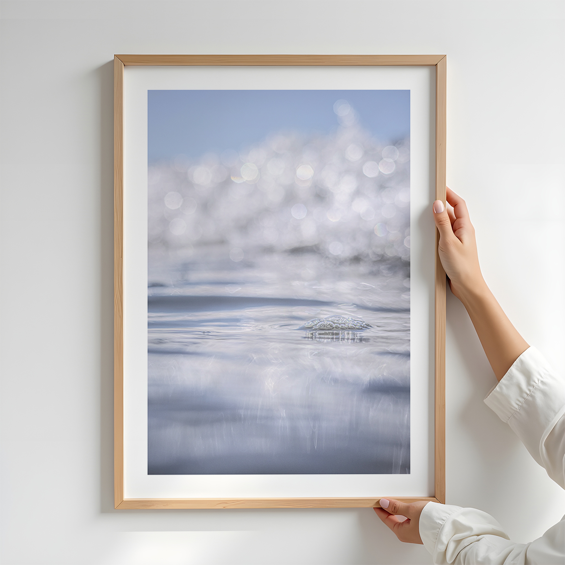 Fine art ocean photography print, captured at sea level in New Zealand. Soft blue tones, sparkling reflections, and dreamy bokeh light create a peaceful and atmospheric coastal artwork.